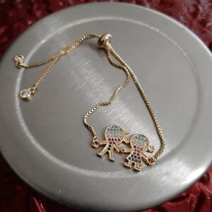 "Gold Charm Bracelet with Colorful Accents"